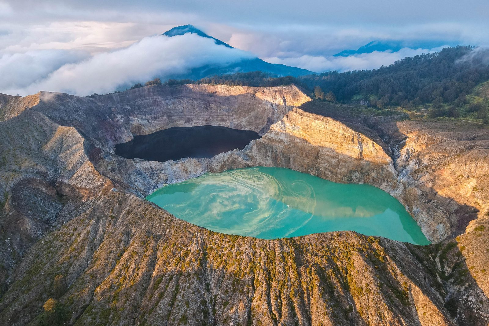 Two of Kelimutu's crater lakes seen from the rim at sunrise